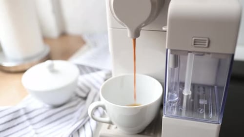Espresso Machine Dispensing Coffee into White Mug