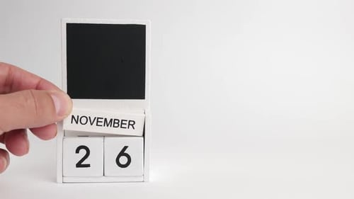 Hand Turns Calendar to November 26 Date