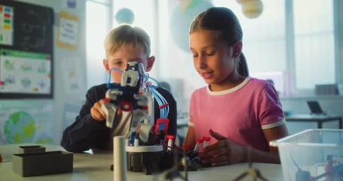 Elementary School Students Studying Model of Innovative Robotic Arm in Modern Classroom