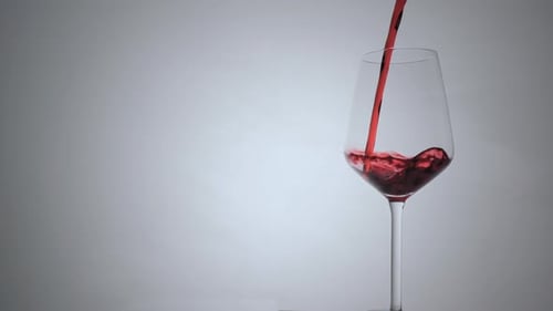 Wine Pouring in Wine Glass on White Background