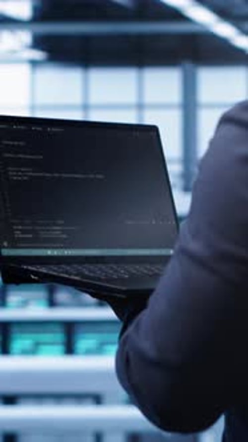 Vertical Video Programmer in Data Center Doing Yearly Maintenance Checkup Using Laptop