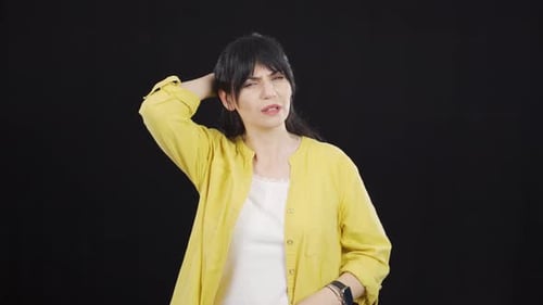 Worried Woman with Hands on Head in Studio
