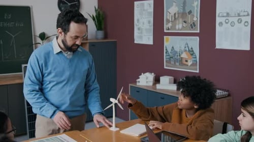 Teacher Explains Wind Turbine to Students in Classroom
