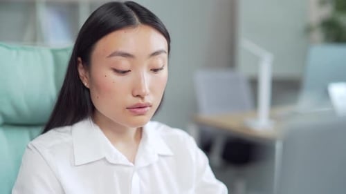 Young Adult Woman Working at Computer in Office