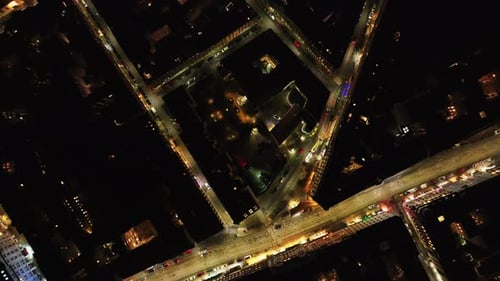 High Angle View of Illuminated Streets Between Dimmed Blocks of Residential Building in Night City