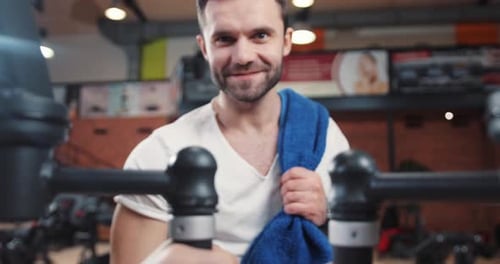 Man with towel talking in a gym