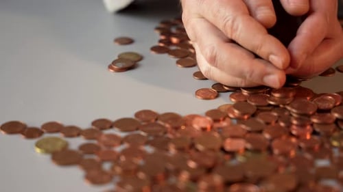 A pile of coins with a gold one in the middle