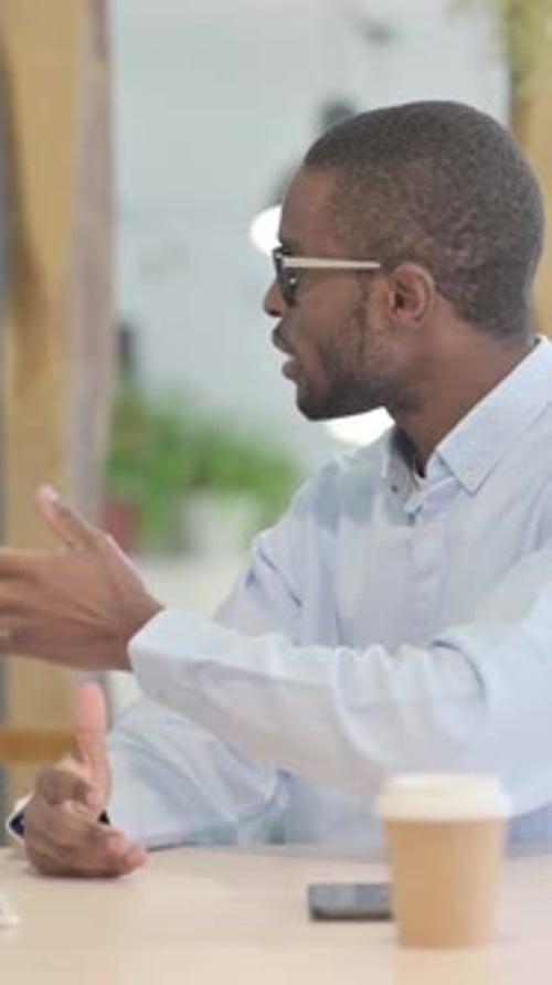 Young Woman Talking to African Man in Office, vertical video