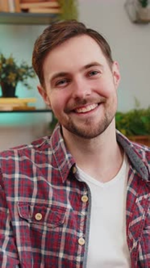 Man Smiles Directly at Camera Indoors