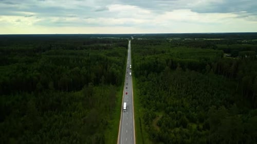 Aerial Footage Shows a Rural Highway Through a Dense Forest Displaying the Natural Landscape From