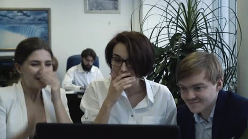 Business Team Celebrating Success on Laptop in Office