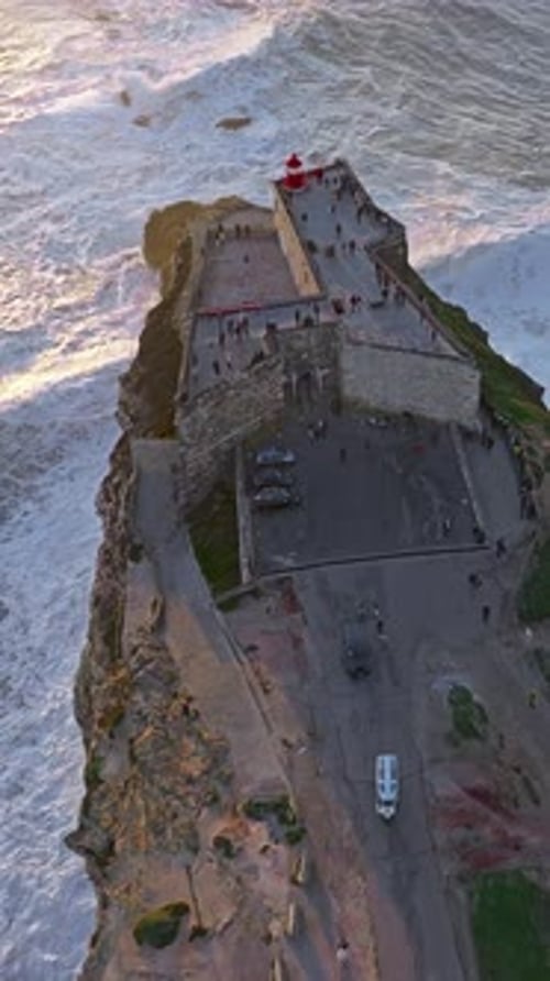 Aerial View of Nazare LighthouseThe World's Biggest Waves Crashing Against the Rocks of the Stunning