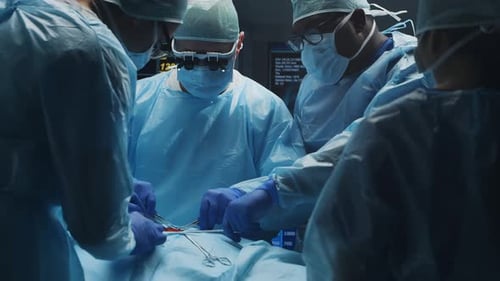 Multiracial Team of Professional Medical Surgeons Performs the Surgical Operation in a Modern