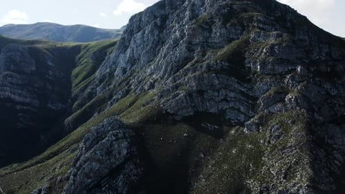 An impressive drone view of a massive mountainside covered in rugged rocks, showcasing the raw beaut