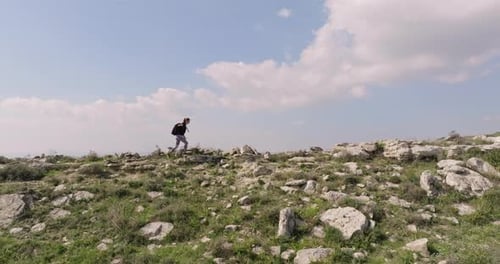 Aerial View Caucasian Athletic Woman with Backpack Hiking in the Mountains