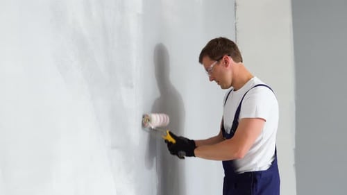 Man Painting Interior Wall with Roller