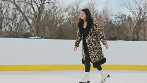 Couple Embracing and Kissing on Outdoor Ice Rink