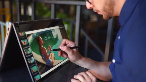 Freelancer Retoucher Man Works on Convertible Laptop Computer with Photo Editing Software Using