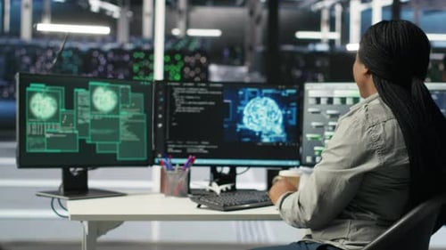 Server Farm IT Expert Responds to Security Breach Alert Displayed on PC Monitor