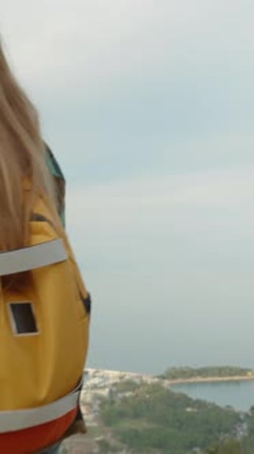 Woman Enjoys Coastal View from Hilltop