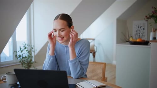 Woman Using Laptop Computer During Video Call at Home