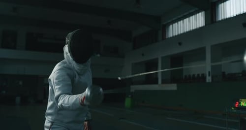 Cinematic slow motion shot of two professional young people is practising assaults of fencing with