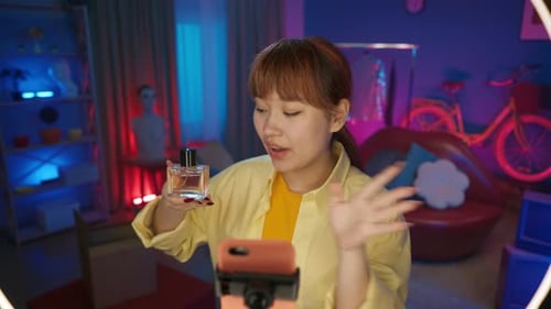 Fashionable Woman Reviewing Perfume in Colorful Room