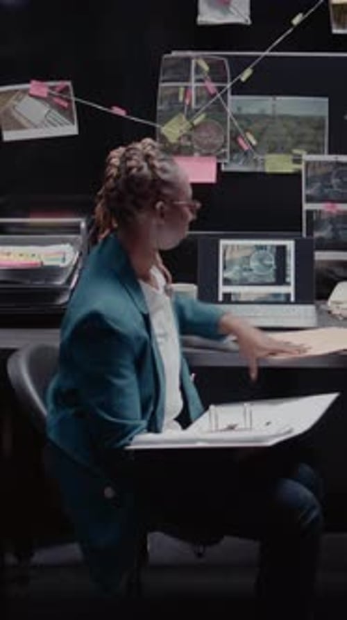 Woman Working at Desk Examining Documents