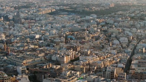 Aerial view panning overlook of unique architecture of Malta, on a sunny evening