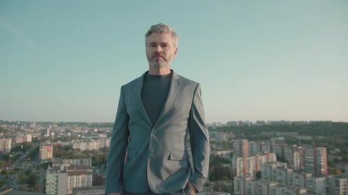 Portrait Young Business Man in Suit Standing Look at Camera on Roof Top at City Skyscraper Slow