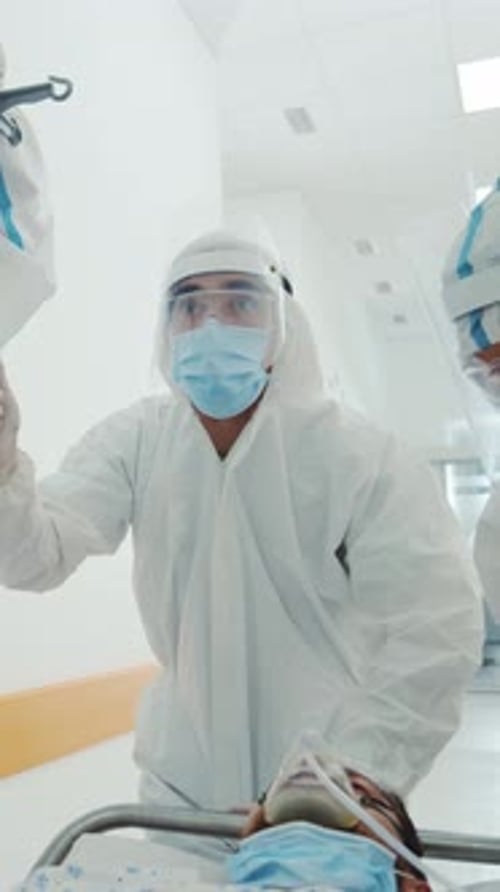 Medical Staff Pushing Gurney in Hospital