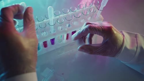 Scientist Performs Lab Experiment with Pipette and Slides