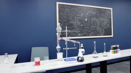 Laboratory Glassware in Front of a Blackboard