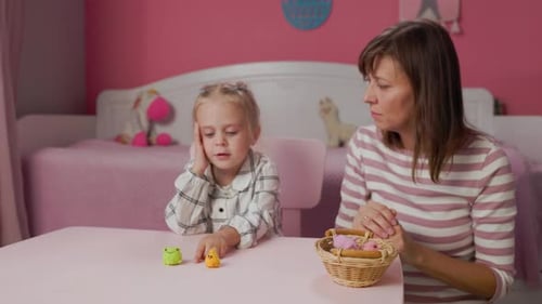 Child Plays Memory Game With Woman Indoors