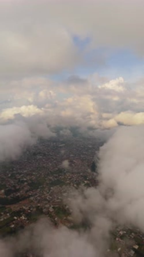 Aerial view of city amidst clouds and sky