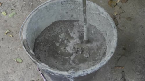 Mixing cement with a handheld mixer tool