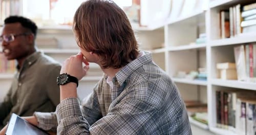 Library, study and student man listening to group conversation and book planning for college