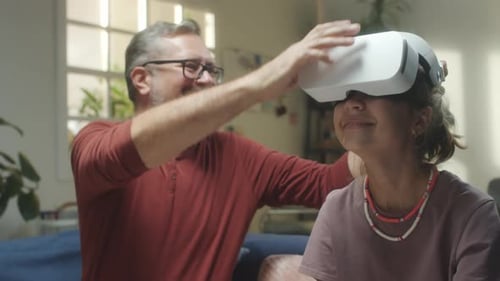 Father Puts VR Headset on Teenage Girl