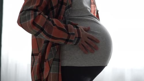 Close Up of Pregnant Woman Holding Belly