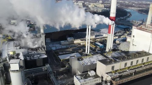 Aerial shot of curling steam from a chimney of a thermal power plant in Poland