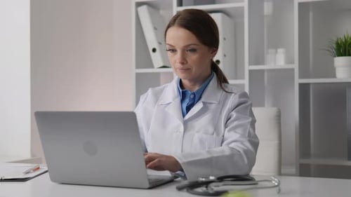 Female Doctor Working on Laptop in Office