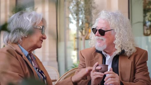 Senior Couple Enjoying Coffee Together at Outdoor Cafe