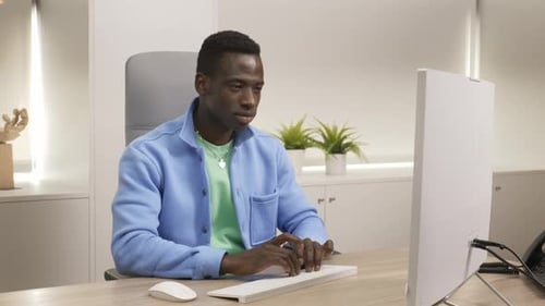 Focused Employee Typing on Keyboard in Modern Office