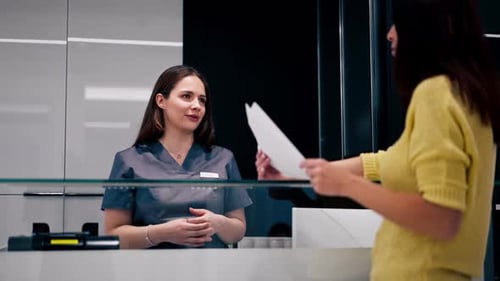 the administrator receptionist meets the client in the beauty salon and consults him in the clinic