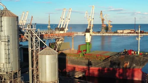 Aerial of Wheat Loading to Bulker Ship Cargo Hold at Sea Grain Elevator in Sea Port Wheat Shipment