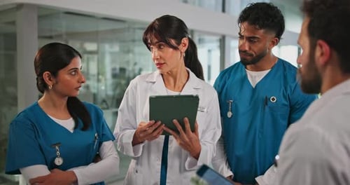 Doctor, tablet and team discussion in clinic for surgery schedule, task delegation or planning