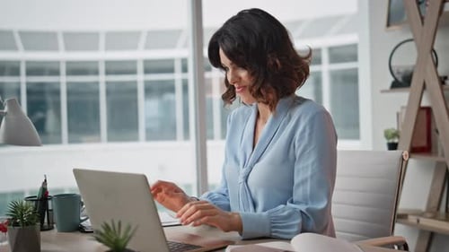Stylish Woman Using Laptop in a Modern Office