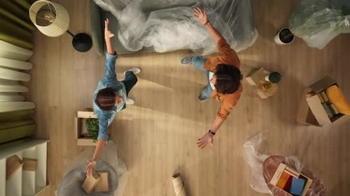 Top View Apartment Living Room Couple in New Apartment Happy Expression Man Holding Woman on Hands