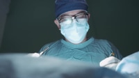 Surgeon Performing Operation With Scalpel in Operating Room