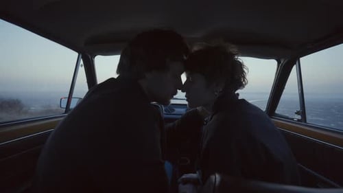 Silhouette of Couple in Car at Twilight